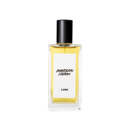 A glass perfume bottle filled with light amber liquid. A white label reads 'American Cream'.