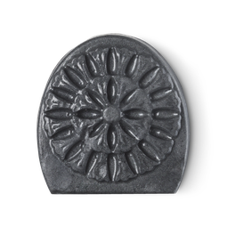 Charcoal. A dark grey, slightly shimmery, semi-oval shaped facial soap with an intricate engraving design.