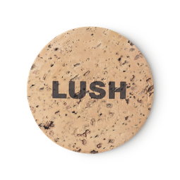 Cork Pot. A round, beige, product holder made of natural cork. LUSH is printed on top, in black, bold letters.