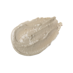 A swatch of smooth, moist-looking light beige coloured Cosmetic Warrior face mask, with visible flecks of green grape.