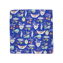 Dad's Shirt Knot Wrap, covered in illustrated leaves and fruits in shades of blue and orange, on a white speckled blue backdrop.