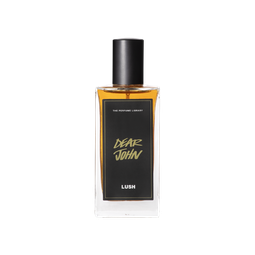 A glass perfume bottle filled with dark amber liquid. A black label reads 'The Perfume Library' and 'Dear John'.