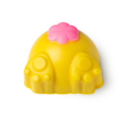 Down The Rabbit Hole, a yellow body scrub in the shape of a rabbits behind, with its paws out and a pink puffy tail. 