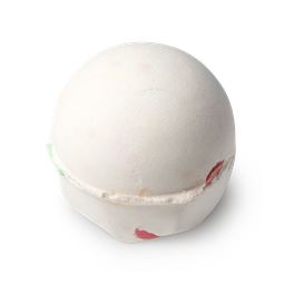Dragon's Egg. A round, cream coloured bath bomb. Fragments of coloured rice paper confetti pieces are visible.