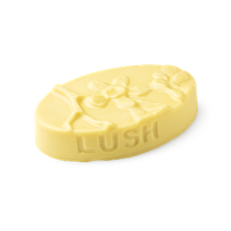 Each Peach (And Two's A Pair). A buttery yellow, oval shaped, solid massage bar, with an embossed orange fruit flower design.