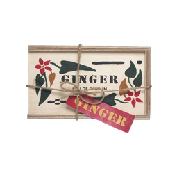 Ginger. A rectangular wooden box, with 'Ginger' 'Eau de Parfum' painted onto it, tied up with brown string and a red gift tag.