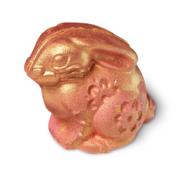 Gold Rabbit, a bunny shaped bath bomb covered in gold with pink blush colouring and engraved flower patterns.