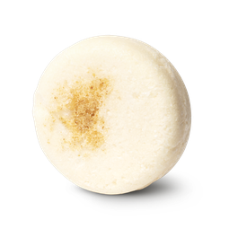 Honey I Washed My Hair. A cream coloured, circular solid shampoo bar, with honeycomb pressed into the top.