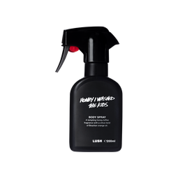 A spray bottle containing Honey I Washed The Kids body spray, made of opaque black Lush plastic.