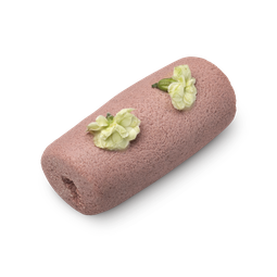 Illipe of Faith. A light pink, cylindrical sugar cleanser roll with a granular texture and topped with fresh white flowers.