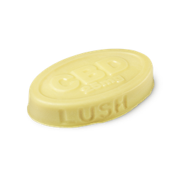 Joints. A buttery yellow, oval shaped, solid massage bar, with LUSH imprinted on its edge, and CBD 25mg embossed on top.