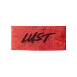 A bright red, rectangular washcard, consisting of apple pulp, with 'Lust' written across it in black Lush writing.