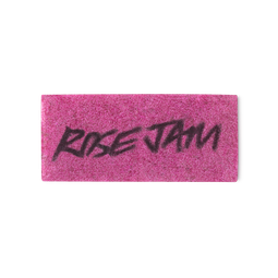 A fuchsia coloured, rectangular washcard, consisting of apple pulp, with 'Rose Jam' written across it in black Lush writing.