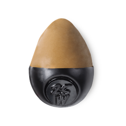 Slap Stick 25W. A medium dark-warm, caramel brown, egg-shaped solid foundation, with a black wax base.