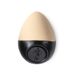Slap Stick 4C. A light-cool, light beige coloured, egg-shaped solid foundation, with a black wax base.