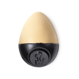 Slap Stick 9W. A light-warm, yellowy, warm beige coloured, egg-shaped solid foundation, with a black wax base.