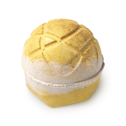 Turmeric latte. A yellow and gold round bath bomb with hatching on top and a cream-coloured stripe down the middle
