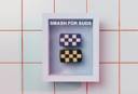 Both Checked Out and Checked In soaps displayed together in a frame on a white and red tiled background.