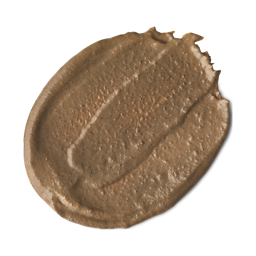 Ayesha. A round swatch of creamy, brown,  visibly-textured face mask.