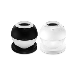 Bath Bot. Two slick, bath bomb-shaped speaker gadgets with a flat base and modern design. One is fully white and the other is black and white. There is an embossed power button visible and the word "LUSH". 
