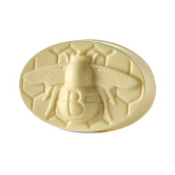 Bee. A thick, oval-shaped solid body balm. The front has a large bee embossed with the letter "B" embossed on the abdomen with a honeycomb pattern surrounding it. 