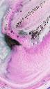 Black Rose bath bomb is buoyant, surrounded by a white, lilac and dark purple foam which is coming out like rays from the sun.
