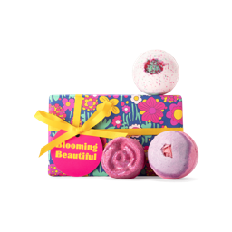 Blooming Beautiful. A rectangular box, wrapped in brightly coloured floral paper, tied with a yellow ribbon and pink gift tag.