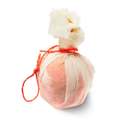 Bonfire bath bomb, an orange bath bomb, wrapped in a muslin cloth, tied up with orange twine.