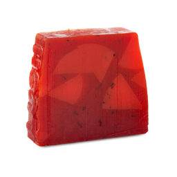 Christmas Cranberry. A tall, trapezium-shaped, partially translucent, deep red soap with flecks of black. The side of the soap is embossed with the word "LUSH" 