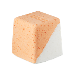 Cold Water Soother. A rounded, cube-shaped bath bomb with a lower diagonal half of crisp white and the top is a peachy-orange colour. There are visible flecks of Epsom salt throughout.