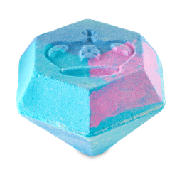 Colour, Clarity, Carat, Cut. A large, hexagonal-diamond-shaped bath bomb with swirls of pink and blue with shimmering lustre throughout. A large crown symbol has been embossed on top. 