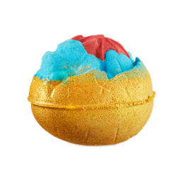 Crackle. A rounded bath bomb shaped like a sleeping dragon inside half an egg shell. The dragon is blue with red wings and the eggshell is bright yellow with a golden lustre. 