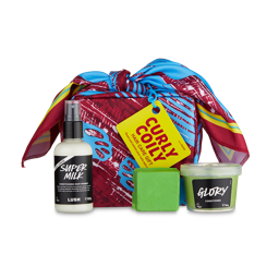 Curly Coily. A box is neatly wrapped in a colourful, exclusive knot wrap with three hair care products consisting of a spray bottle, co-wash and conditioner put beside. 