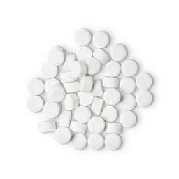 A pile of small, circular, white Dirty toothpaste tabs shot from above. 
