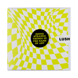 A Square greetings card with a warped white and neon green checkered design. A black badge sits in the centre with green text that reads "Doing Strange Things In The Name Of Art".