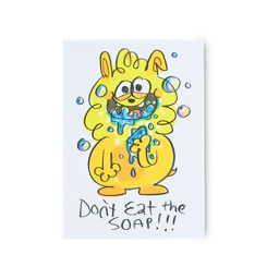 Don't Eat The Soap. A whimsical postcard depicting a friendly yellow monster eating blue soap with bubbles all around.
