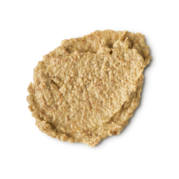 Enzynamite. A round, smudged swatch of pale, golden, creamy face mask with visible textured exfoliating pieces.