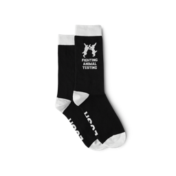 Black socks with the toe, heel and tops white. “Lush” is on the soles with ‘Fighting Animal Testing’ logo and text on the ankle.