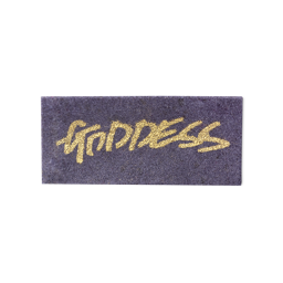 A purple, rectangular washcard, consisting of apple pulp, with 'Goddess' written across it in gold Lush writing.