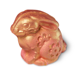 Gold Rabbit, a bunny shaped bath bomb covered in gold with pink blush colouring and engraved flower patterns.