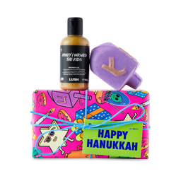 Happy Hanukkah. A pink, colourful gift box with a themed bath bomb and shower gel sitting on top. 