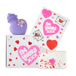 I'm Yours gift. A white gift box covered in hearts containing two Valentine's Day-themed products and a sticker sheet.