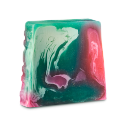 Intergalactic. A large, off-square slice of soap. It is a fresh, turquoise and teal colour with swirling ripples of pink and white Glitter runs through the product and the word "LUSH" is embossed on the side. 