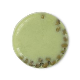 Jade Roller. A circular, lime green naked cleansing balm, with whole mung beans pressed into one side.