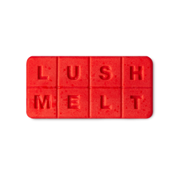 Jasmine Cream. A bright red, flat, oblong wax melt segmented into 8, equal sections spelling out the words "Lush Melt".