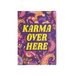 Karma Over Here. A purple postcard with a paisley-style pattern and the words "Karma Over Here" printed in yellow.