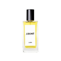 A glass perfume bottle filled with canary yellow liquid. A white label reads 'Karma'.