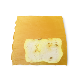 Lemon Zest. A bright yellow, smooth, trapezium shaped soap, with a creamy section in its core, and bumps along its left side.