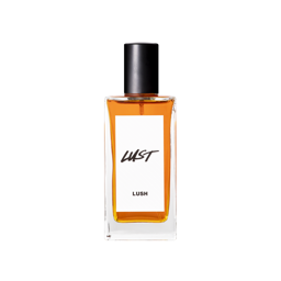 A glass perfume bottle filled with deep, reddish amber liquid. A white label reads 'Lust'.