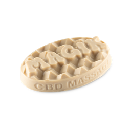 Magik. A classic, creamy, oval LUSH massage bar. The word "Magik" is embossed in bubble writing on top surrounded by an almost honeycomb-style pattern. 